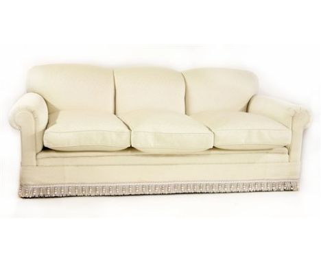 A modern three-seater settee, by Howard Chairs Ltd. with light grey upholstery, on square tapering legs and brass castors, 21