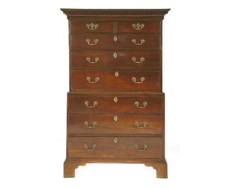A George III mahogany chest on chest, two short over six graduated long drawers, each with cast pierced brass swan neck handl