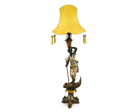 A carved and painted Venetian blackamoor standard lamp, the silk shade with tassels, 142cm high