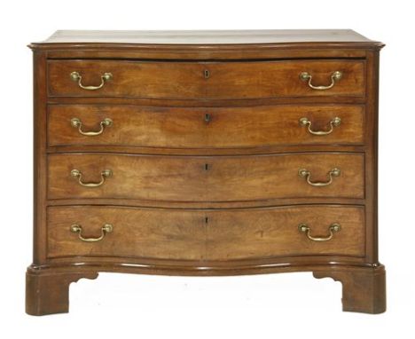 A George III mahogany serpentine commode chest, the top drawer with a slide over three further graduated drawers, flanked wit