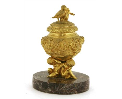 An ormolu inkwell, cover and liner, second half of the 19th century, probably French, the cover with a cast finial depicting 
