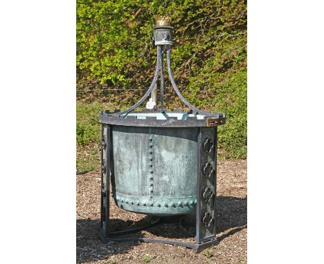A copper and iron fountain, 20th century, formed from a large copper copper mounted on painted iron supports, below a pressed