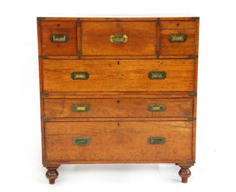 A teak and brass bound campaign secretaire chest, late 19th century, with a central secretaire drawer, with ash interior, and