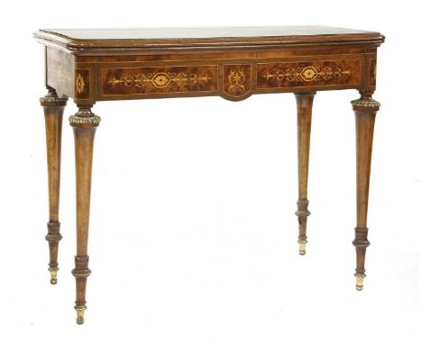 An amboyna inlaid card table, c.1900, the baize inset fold-over top on ring-turned gilt metal-mounted legs, 92cm wide 46cm de