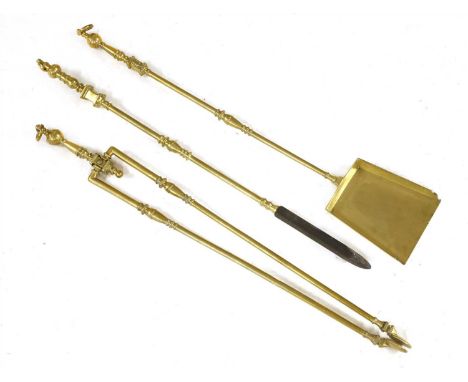 A set of three brass fire irons, late18th century, the ring-turned handles with a suspension loop, each 85cm long approximate