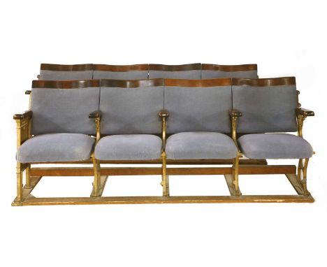 A pair of vintage cinema seats, each with four folding seats on cast iron frames, with a laurel wreath design to one end of e