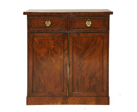 A Regency inlaid mahogany pier cabinet, the moulded rectangular top over two frieze drawers with brass ring handles and inlai