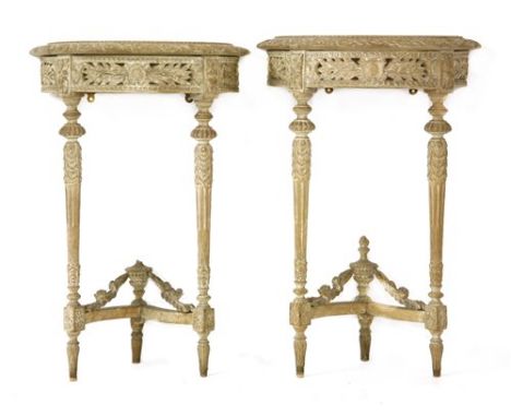 A pair of Louis XVI-style demilune console tables, each with a carved frieze and on turned tapering legs united by a stretche