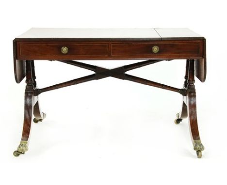 A Regency mahogany sofa table, rosewood-crossbanded and boxwood and ebony strung, on dual-end turned supports with an unusual