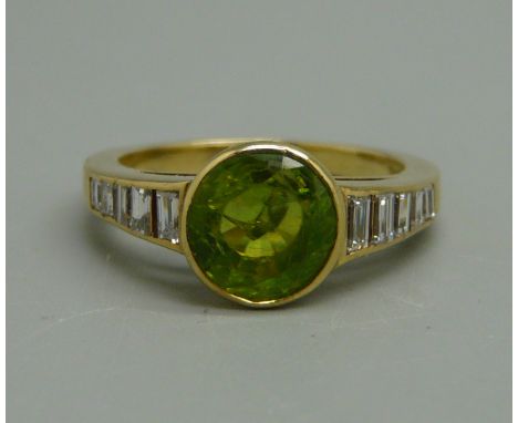 An 18ct gold, peridot and diamond ring, approximately 0.30ct of baguette diamonds, 4g, K 