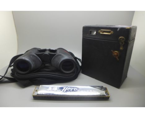 A camera, a pair of binoculars and a harmonica 