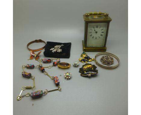 A carriage clock and a bag of costume jewellery 