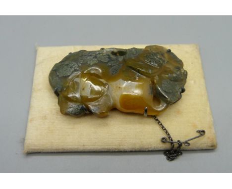 A white metal mounted carved jade brooch 
