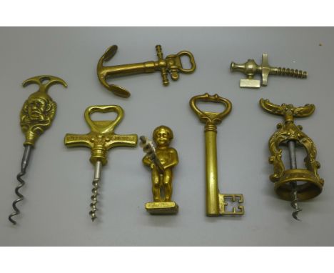 Six vintage brass corkscrews and a champagne tap 