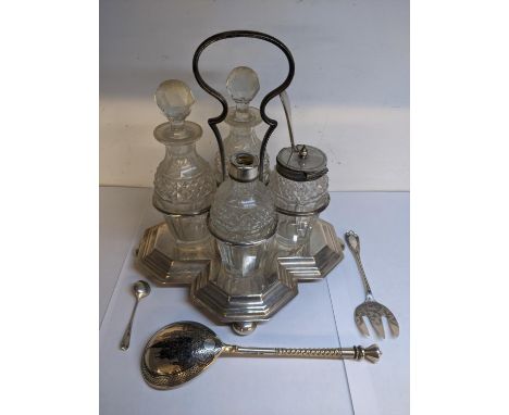 A silver plated cruet set together with a Russian white metal and Niello decorated spoon decorated with a scene of the Kremli