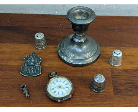 Silver and collectables to include a fob watch, a dwarf candlestick, three thimbles, and an ARP badge Location: 