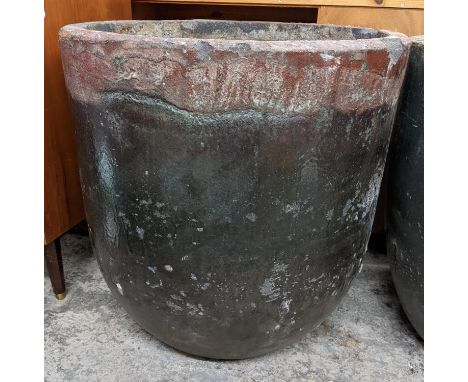 A large foundry glazed smelting pot used as a garden planter 63.5cm h x 61.5cm w Location: 