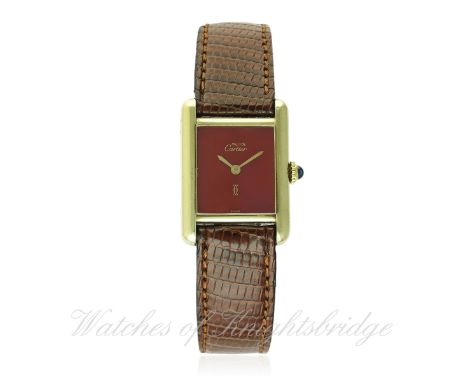 A LADIES SILVER GILT MUST DE CARTIER WRIST WATCH CIRCA 1990s D: Red lacquer dial with gilt hands. M: Manual wind movement sig