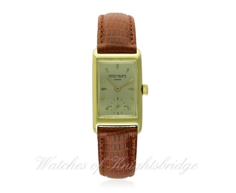 A GENTLEMAN'S SMALL 18K SOLID GOLD PATEK PHILIPPE RECTANGULAR WRIST WATCH CIRCA 1950
D: Silver dial with gold batons & hands,