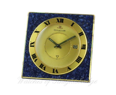 A GILT METAL LACQUERED JAEGER LECOULTRE ALARM TRAVEL CLOCK CIRCA 1970 IN ORIGINAL JLC POUCH
D: Two piece champagne dial, inne