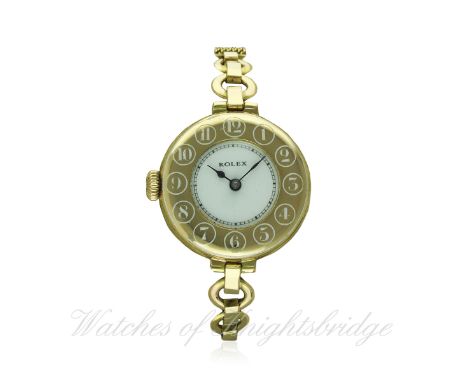 A LADIES LEFT HANDED 9CT SOLID GOLD ROLEX HALF HUNTER BRACELET WATCH CIRCA 1920s
D: White enamel dial with chapter ring. M: 1