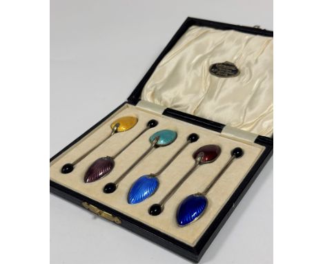 A cased set of six George V silver and enamel coffee spoons, Barker Brothers, Birmingham 1930, the back of each bowl in colou