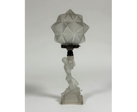 An opalescent glass figural table lamp in the Art Deco taste, the base modelled as a kneeling female nude, supporting a facet