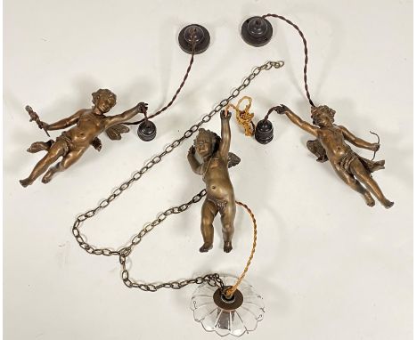 A set of three patinated metal figural hanging lights, early 20th century, each modelled as a putto with upstretched arm susp