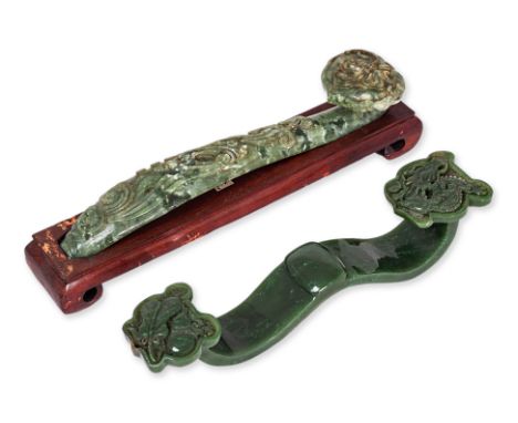 TWO JADE RUYI
Chinese, one example in dark green jade decorated with carved dragon and Buddhist objects, the other decorated 