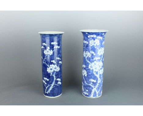 Two Chinese blue and white sleeve vases, c.1900. Both with “cracked ice and prunus” design, the larger one with four-characte