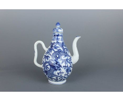 A Chinese blue and white “dragon” ewer, Qing Dynasty late 19th century, the bulbous body decorated with a four-clawed scaly d