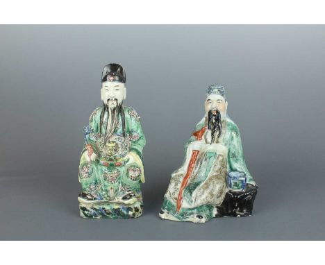 Two Chinese polychrome-enameled porcelain figures, Qing Dynasty 19th century. The forward-facing seated figure (Civil God of 