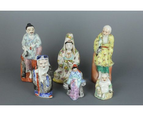 A group of six Chinese porcelain figures, Republican period, including a larger pair of a fisherman and a woodsman, a Buddhis