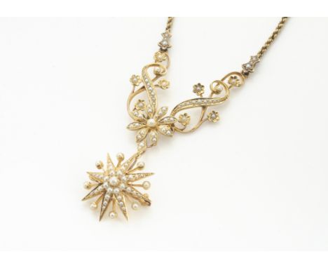 An Edwardian 15ct marked gold and seed pearl necklace, with detachable star drop pendant or brooch, the flower head centre wi