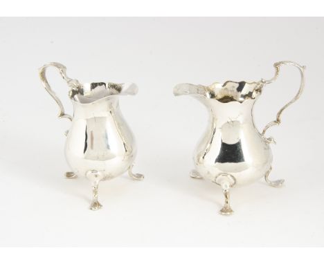 Two George III period silver milk jugs, both similar on three supports, one repaired, 4.5 ozt and 9.5cm