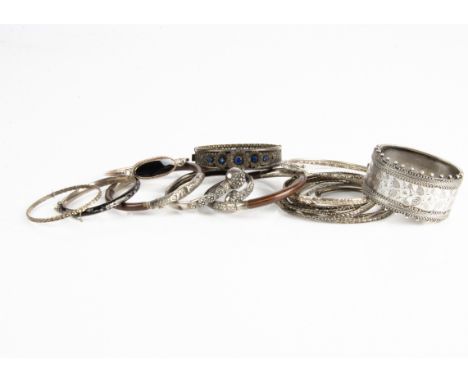 A collection of silver, white metal and base metal bangles, including an enamel and seed pearl mourning example (af), a large