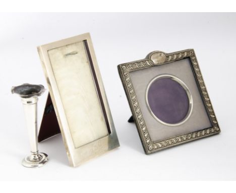 An Edwardian silver fronted square photograph frame, AF, together with a rectangular German silver example and a small George