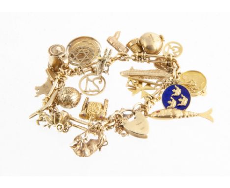 An 18ct gold converted watch chain, set with twenty five mixed gold charms, including Spanish matador tunic, 9ct gold globe, 