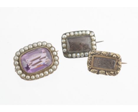 Two 19th Century plaited hair mourning brooches, one with seed pearl surround the other with a floral chased design with engr