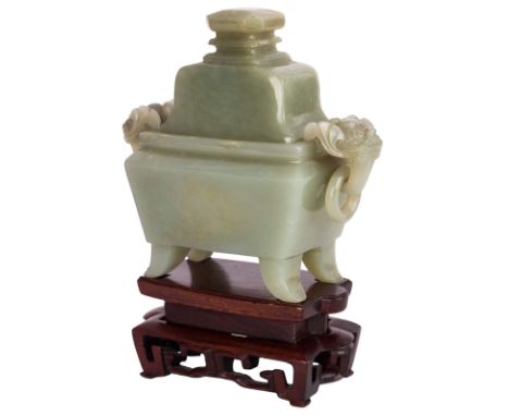 A CELADON JADE VESSEL AND COVER, QING DYNASTY, 1644-1911resting on four splayed legs, the rectangular section flanked by a pa