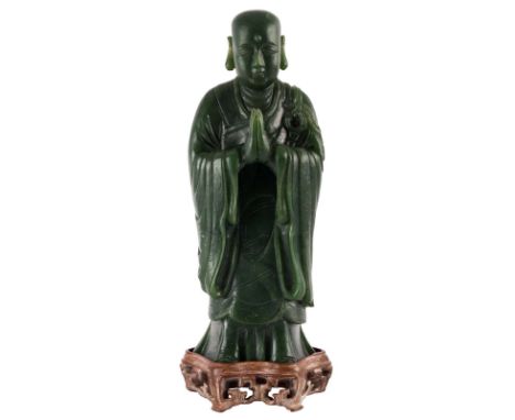 A DARK GREEN JADE CARVING OF ANANDA, QING DYNASTY, 1644-1911standing upright, the figure of Ananda, Buddha`s principal discip