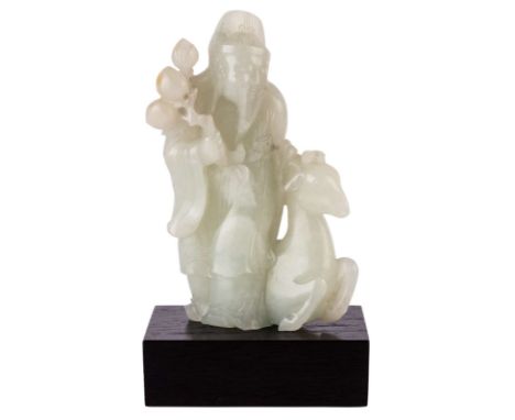 A CHINESE PALE CELADON JADE GROUP OF SHOU LAO AND DEER, QING DYNASTY, 1644-1911the standing deity dressed in long flowing rob