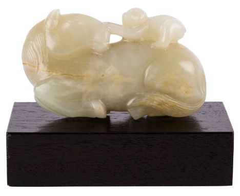 A PALE CELADON JADE OF A RECUMBENT HORSE WITH MONKEY GROUP, QING DYNASTY, 18TH CENTURYthe reclining horse carved with its hea