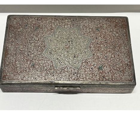 A ornately decorated white metal box with red enamel decoration 