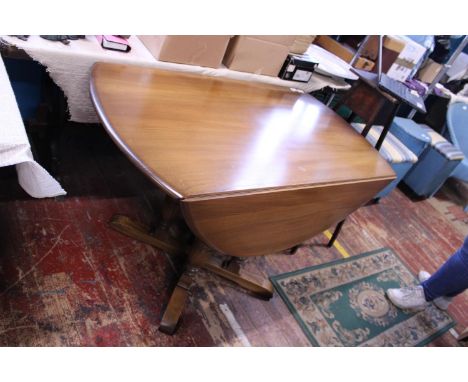 A mid-century Ercol drop leaf dining table.Shipping unavailable. 