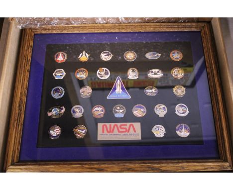 A framed NASA collection of enamel badges 