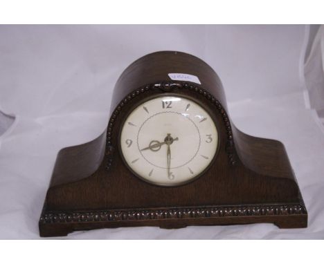 A wooden cased mantle clock (wind up movement), shipping unavailable 