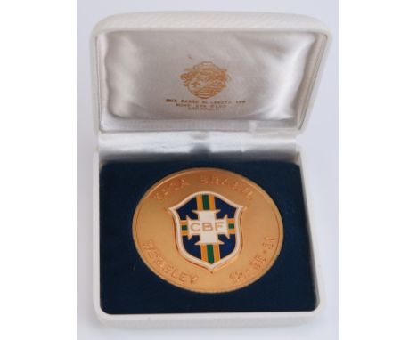 A gilt metal and enamel commemorative medallion England V Brazil, Wembley 12-05-81, with CBF enamel shield to the centre. 59m