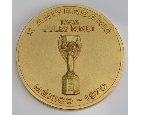 A Brazilian gilt metal 10th anniversary medallion of the 1970 Mexico World Cup, obverse CBF enamel shield logo and three star