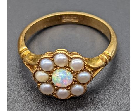 An 18ct gold ring mounted with a single opal surrounded with pearls, 4g, size K/L